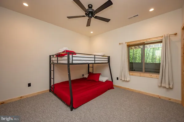 a living room with furniture a table and kitchen view