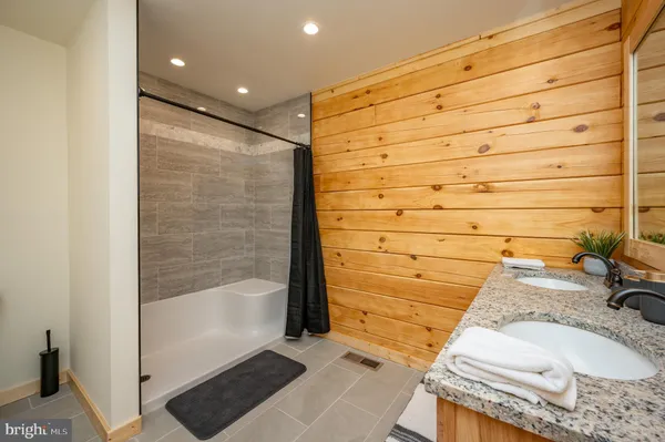a living room with furniture pool table and flat screen tv