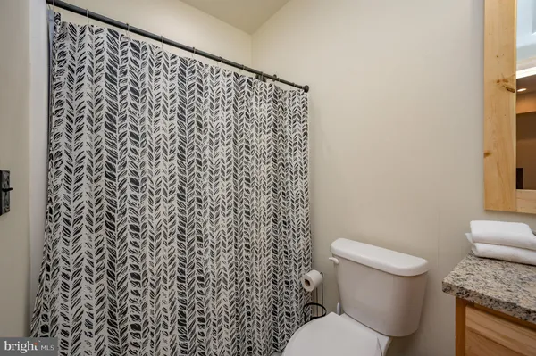 a kitchen with stainless steel appliances granite countertop a sink and a refrigerator