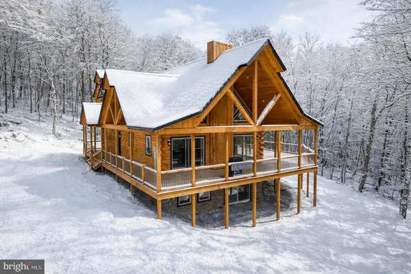 a living room with fireplace furniture and a large window