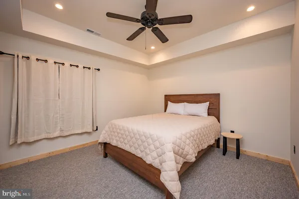 a living room with furniture a fireplace and a floor to ceiling window