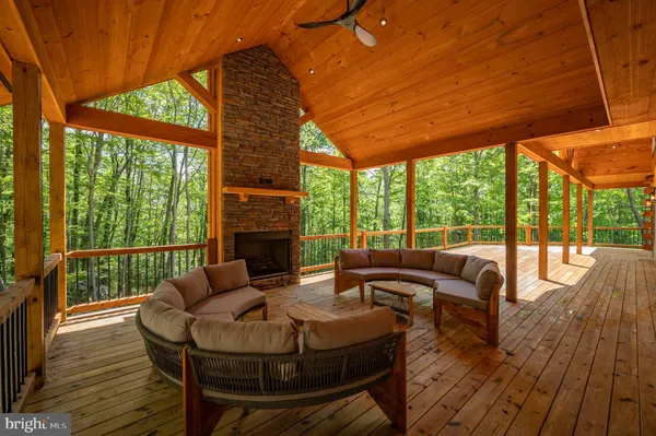a view of an house with wooden fence and a floor to ceiling window
