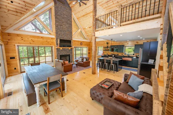 a living room with furniture a large window with kitchen view