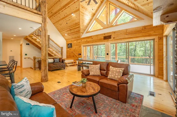 a living room with furniture a fireplace and a chandelier
