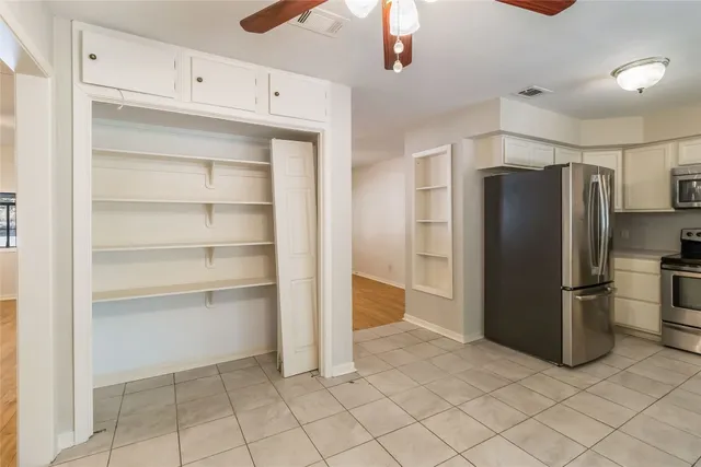 a kitchen with a refrigerator and a refrigerator