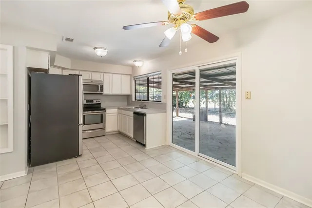 a kitchen with stainless steel appliances a refrigerator and a sink