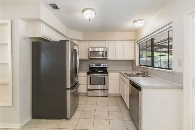 a kitchen with a stove a sink and a refrigerator