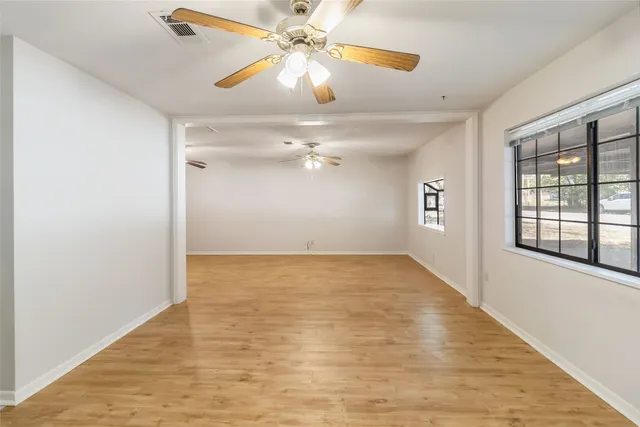 wooden floor in an empty room with a window