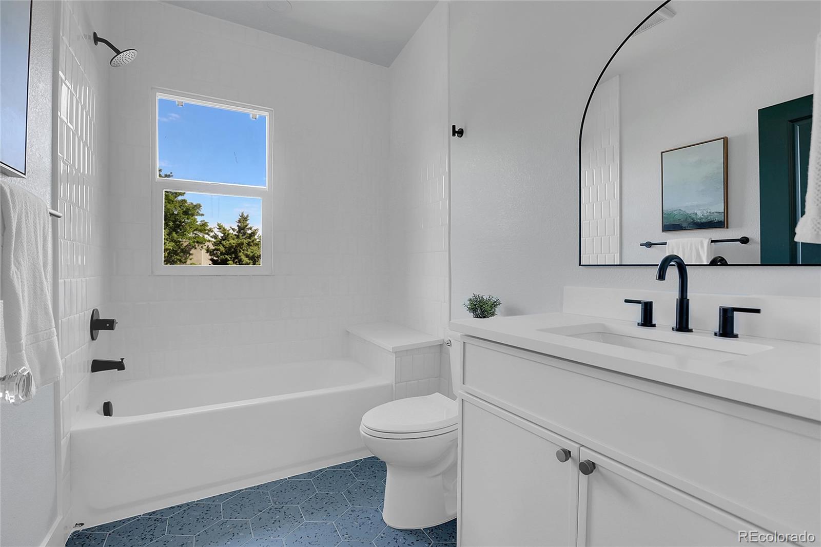 1260 Garfield Street Denver, CO 80206 - Photo 11 of 24 a bathroom with a granite countertop sink a toilet and bathtub