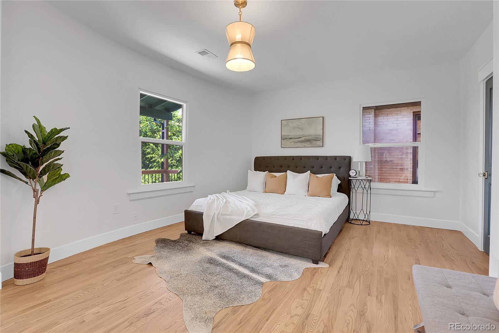 1260 Garfield Street Denver, CO 80206 - Photo 12 of 24 a bedroom with a bed and a window