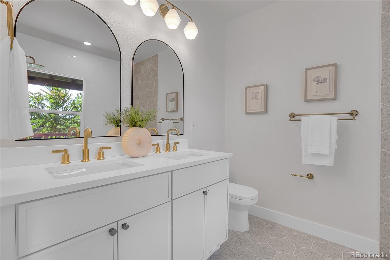 1260 Garfield Street Denver, CO 80206 - Photo 14 of 24 a bathroom with a toilet a sink and mirror
