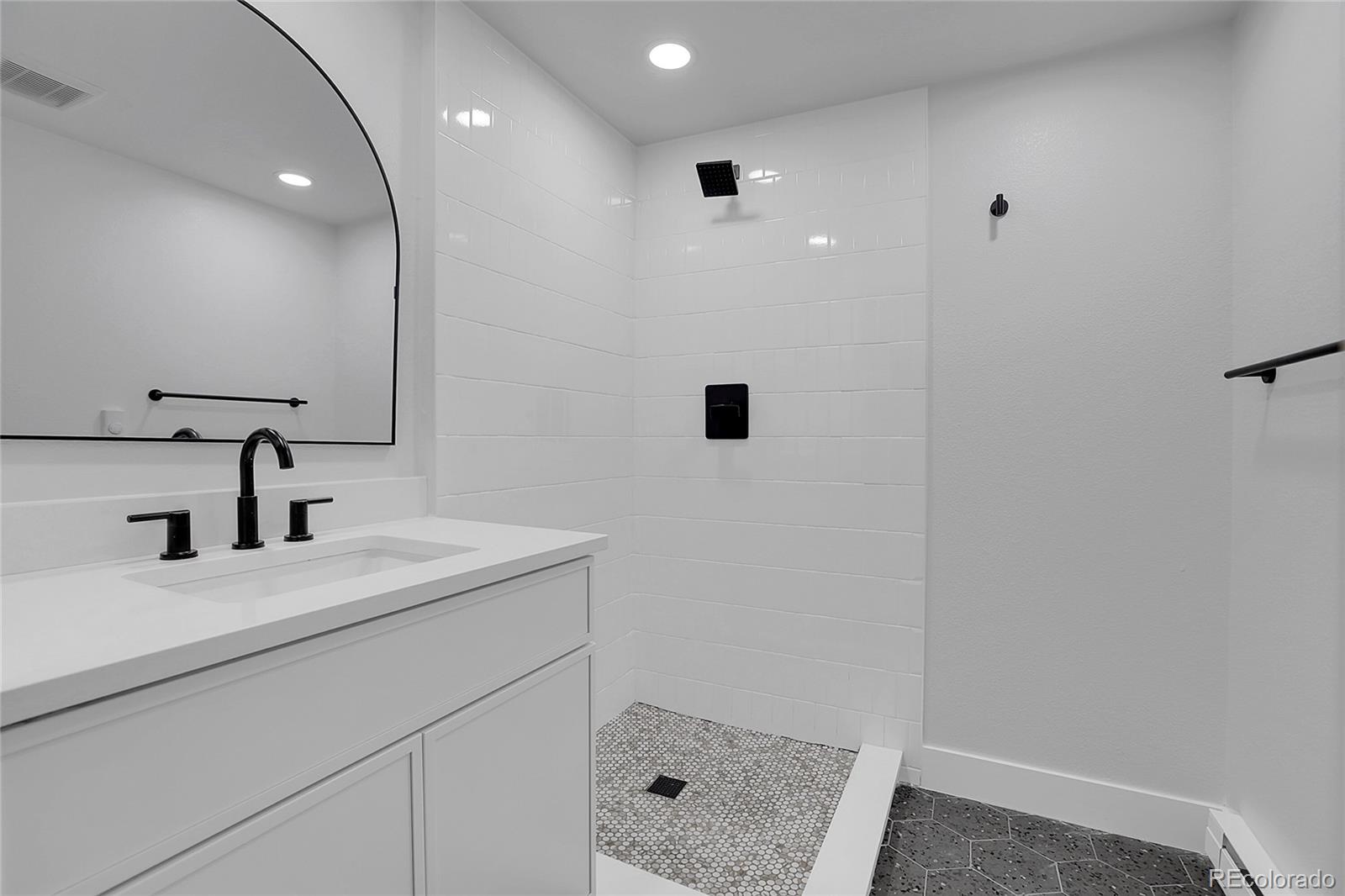 1260 Garfield Street Denver, CO 80206 - Photo 18 of 24 a bathroom with a sink a toilet and shower