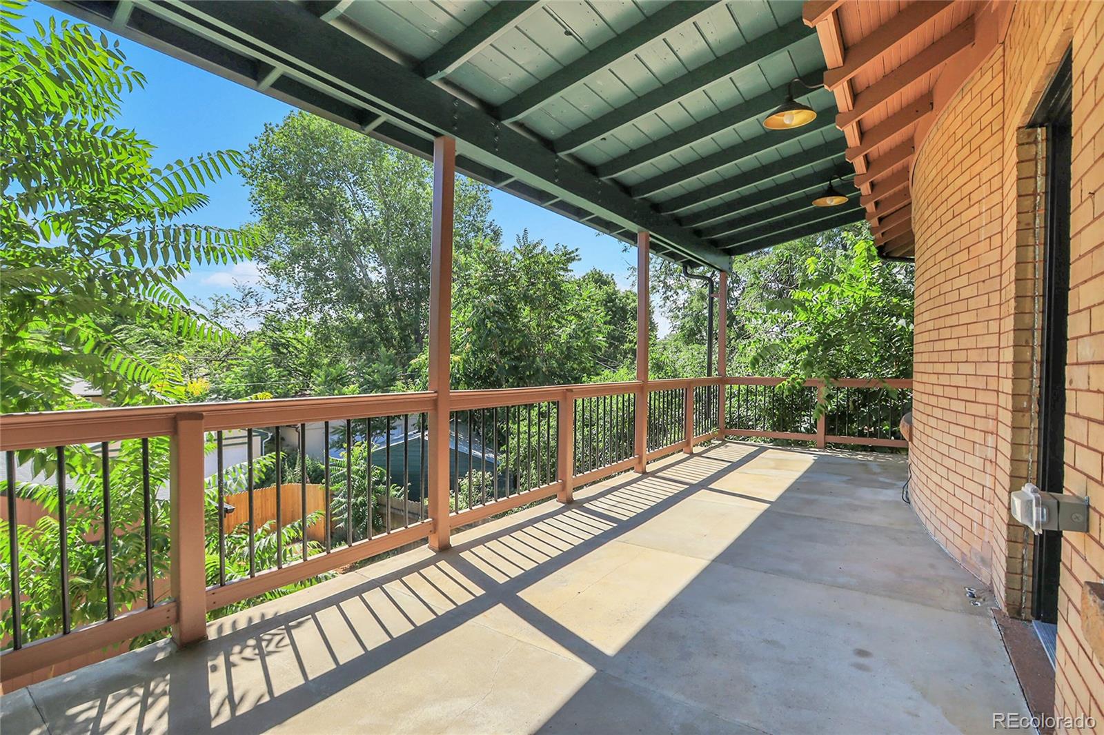 1260 Garfield Street Denver, CO 80206 - Photo 24 of 24 a view of balcony with wooden floor and fence