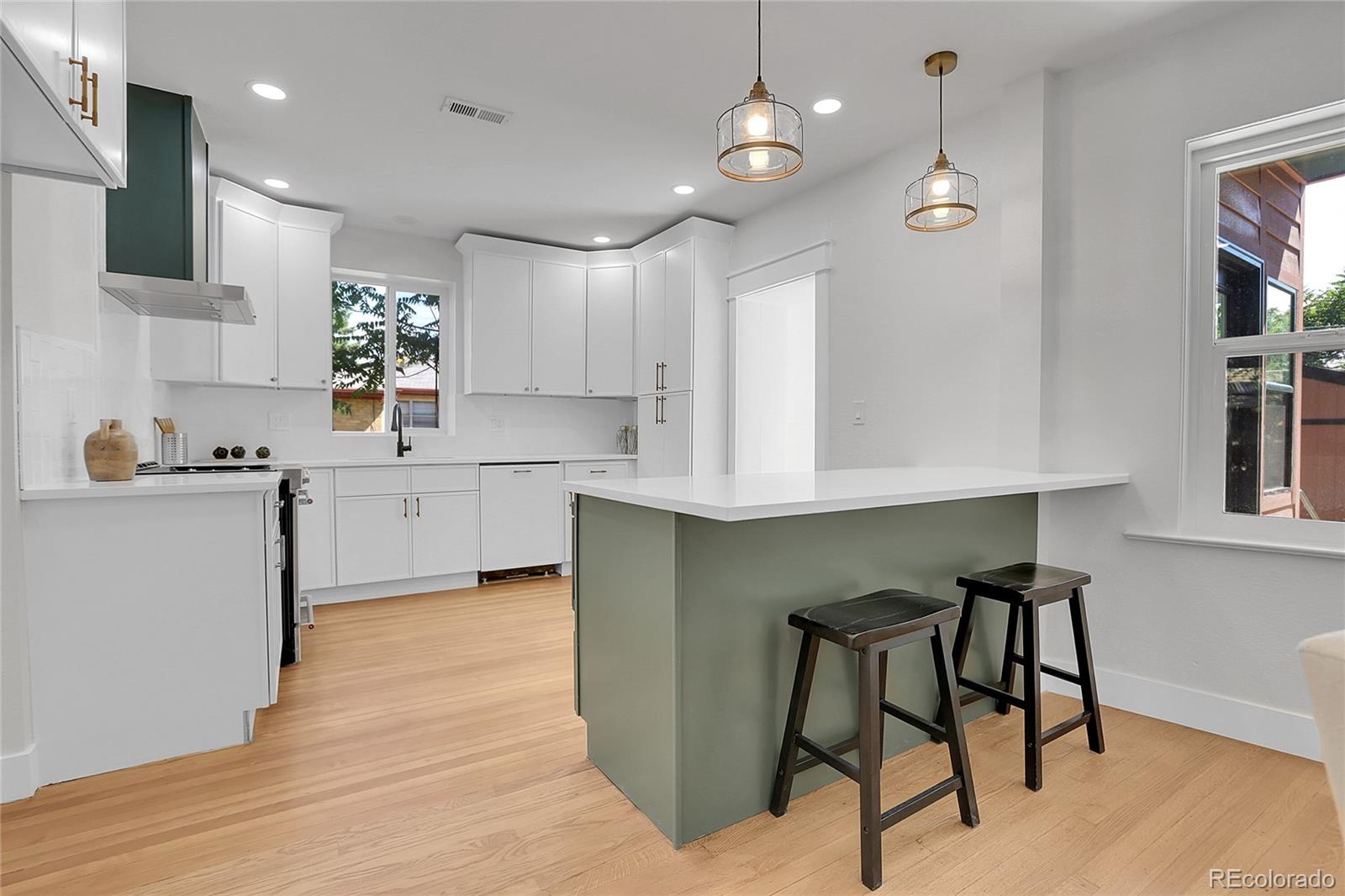 1260 Garfield Street Denver, CO 80206 - Photo 7 of 24 a kitchen with a sink cabinets and window