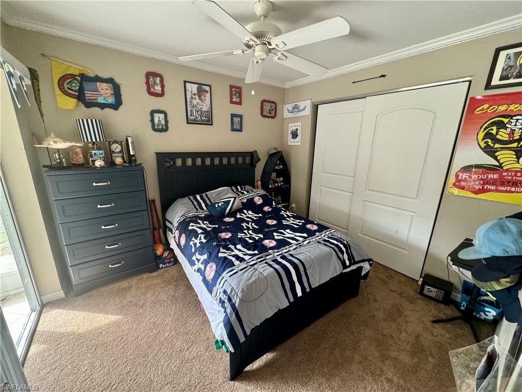 276 Madison Drive Naples, FL 34110 - Photo 12 of 22 a bedroom with a bed and a dresser