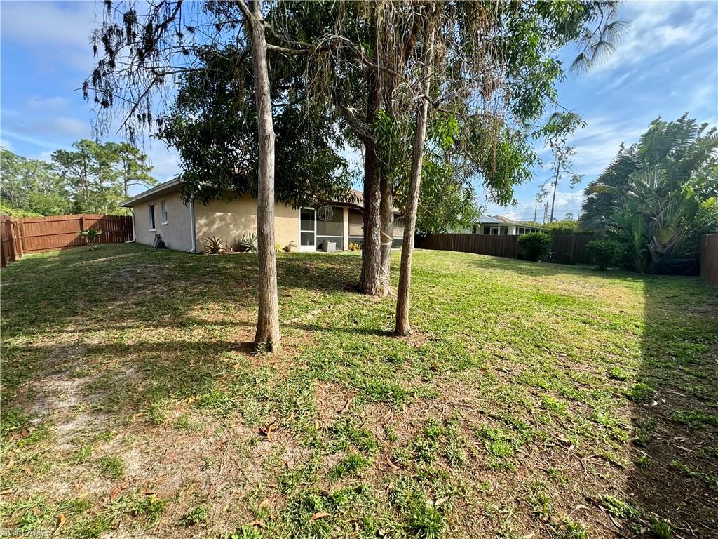 276 Madison Drive Naples, FL 34110 - Photo 19 of 22 a backyard of a house with lots of green space