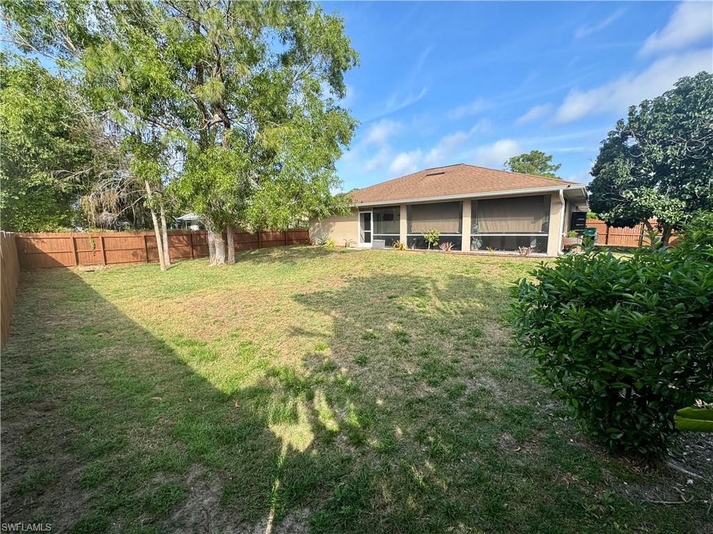 276 Madison Drive Naples, FL 34110 - Photo 20 of 22 a front view of a house with a yard