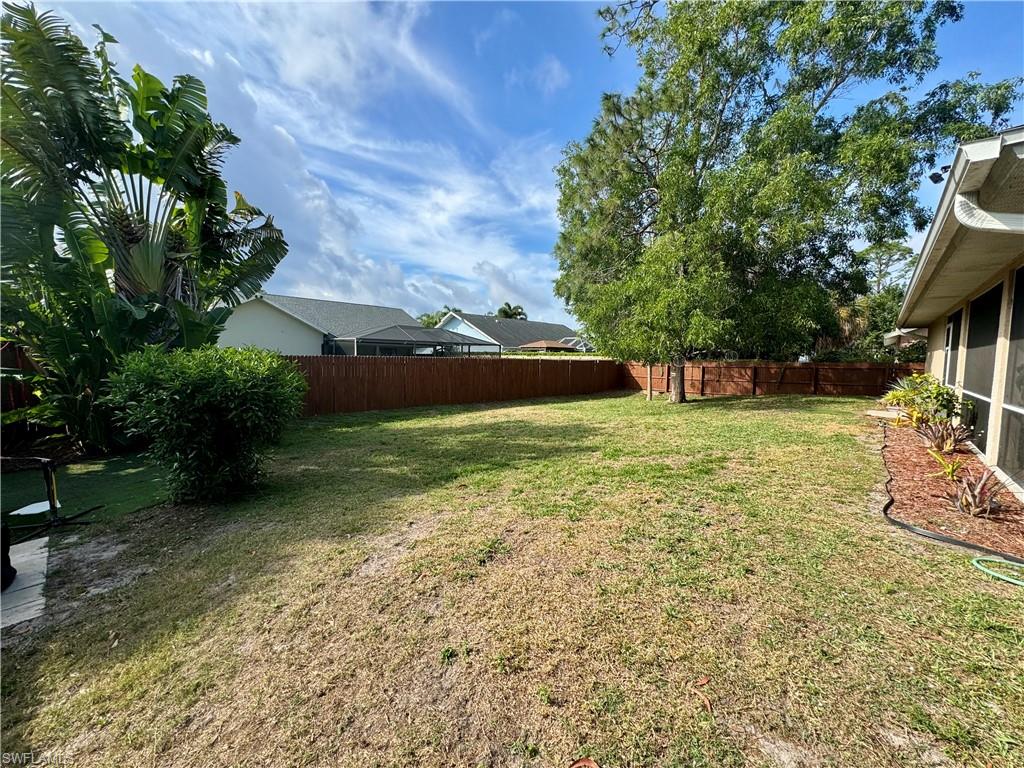 276 Madison Drive Naples, FL 34110 - Photo 21 of 22 a view of a backyard with a garden