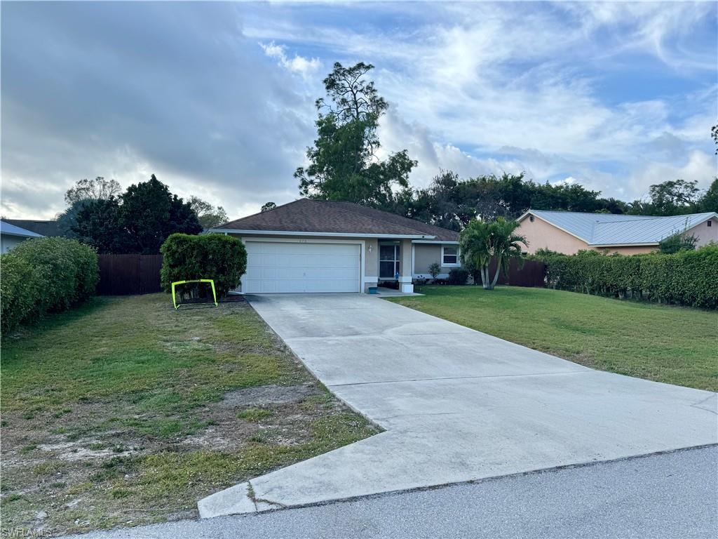276 Madison Drive Naples, FL 34110 - Photo 22 of 22 a front view of a house with garden