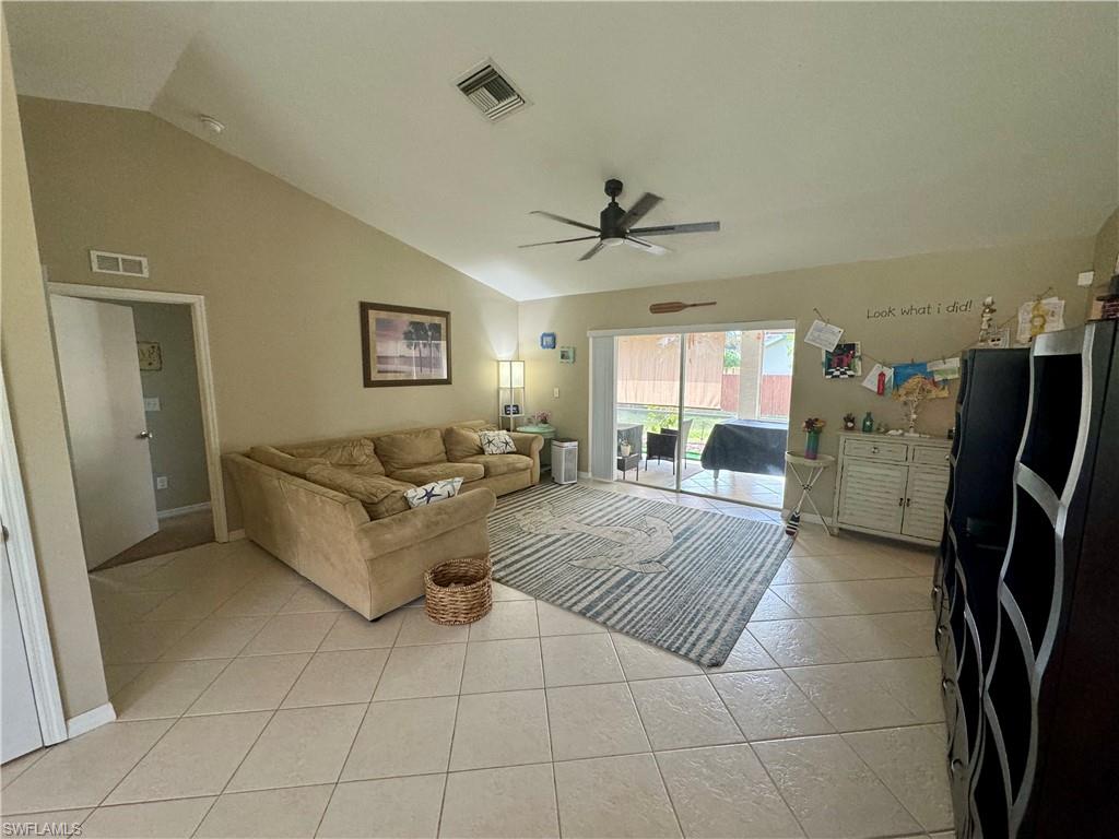 276 Madison Drive Naples, FL 34110 - Photo 5 of 22 a living room with furniture and a flat screen tv