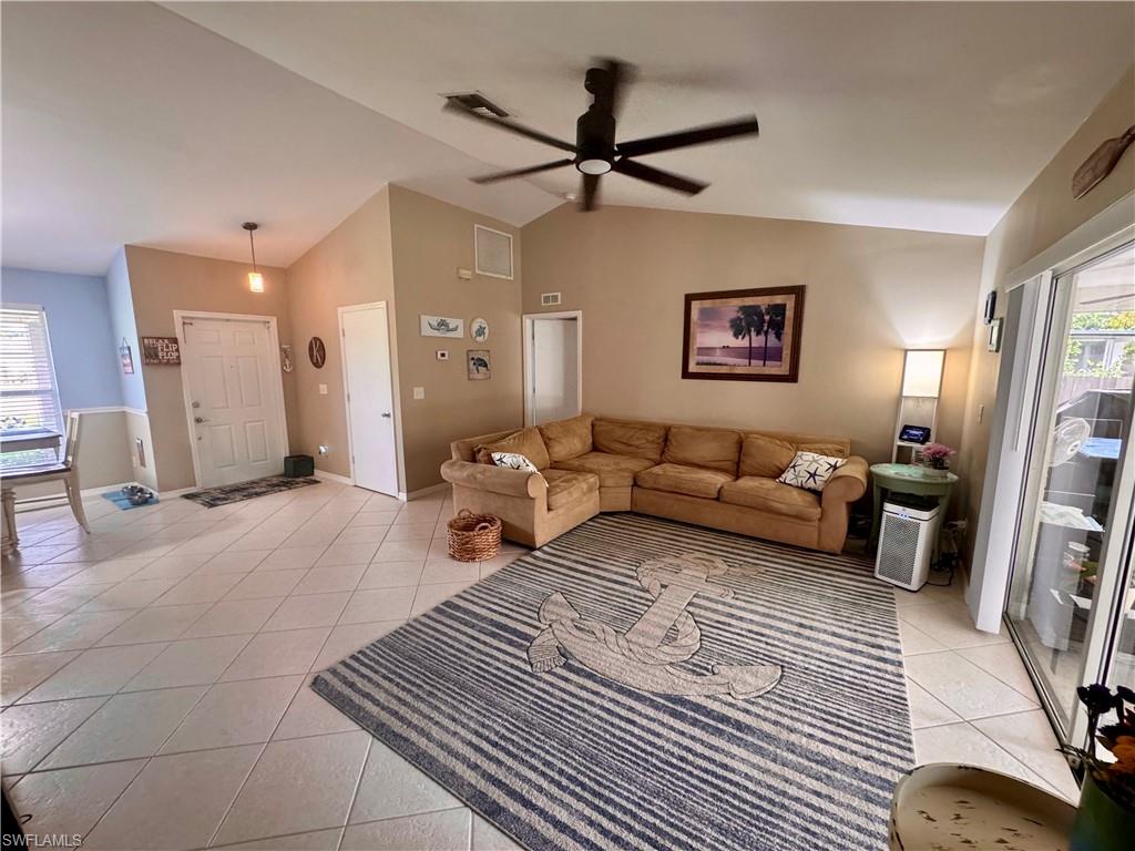 276 Madison Drive Naples, FL 34110 - Photo 6 of 22 a living room with furniture and a rug