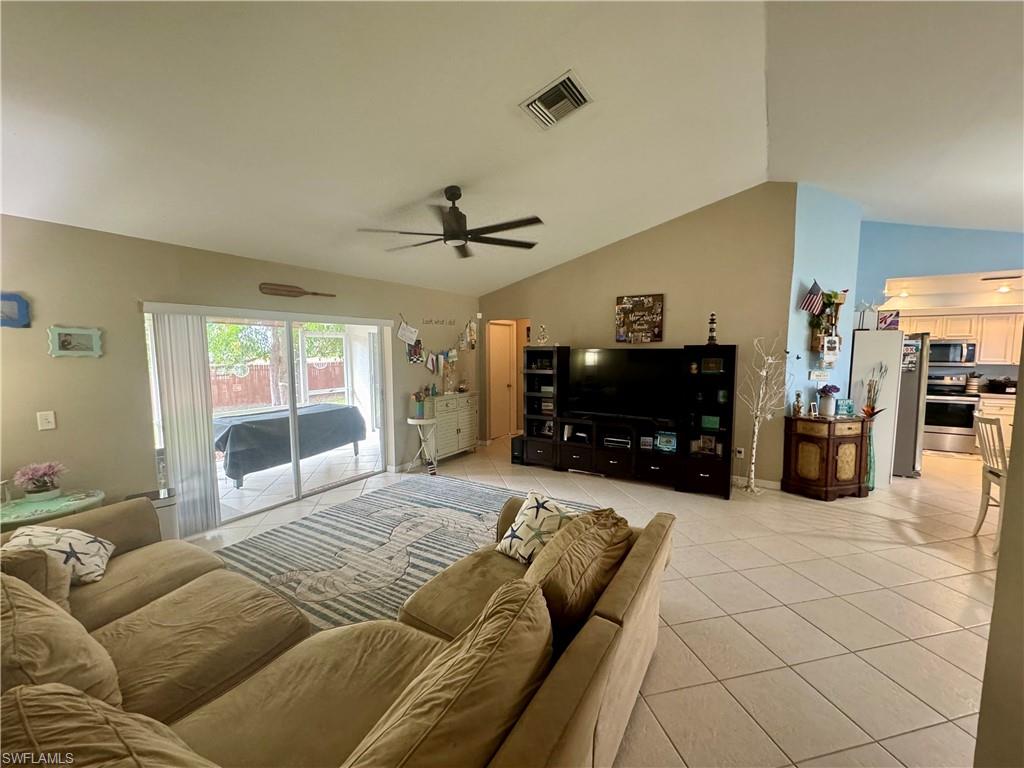 276 Madison Drive Naples, FL 34110 - Photo 7 of 22 a bed room with a bed mirror and a couch