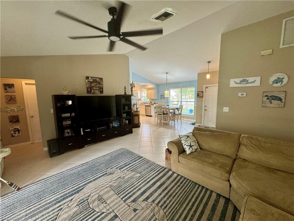 276 Madison Drive Naples, FL 34110 - Photo 8 of 22 a living room with furniture and a flat screen tv