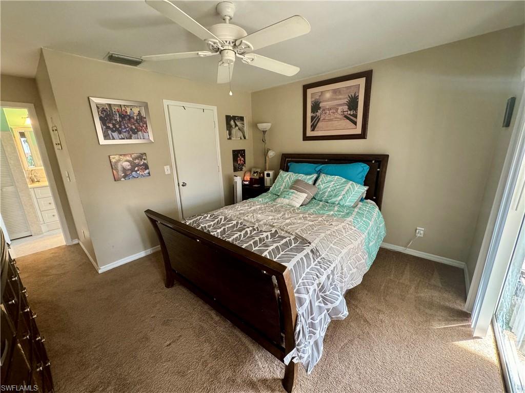 276 Madison Drive Naples, FL 34110 - Photo 10 of 22 a bed sitting in a bedroom next to a window
