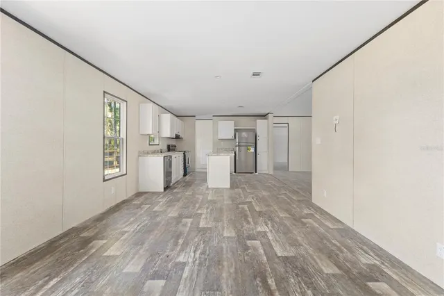 a view of a kitchen with a refrigerator cabinets and a window