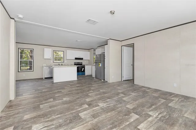 a view of a kitchen with a refrigerator cabinets and a window