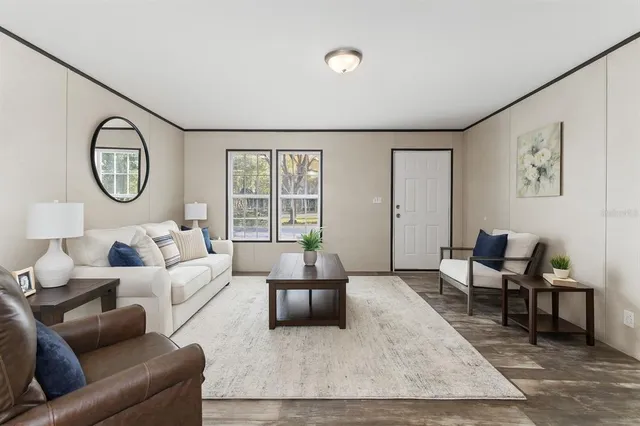 a living room with furniture wooden floor and window
