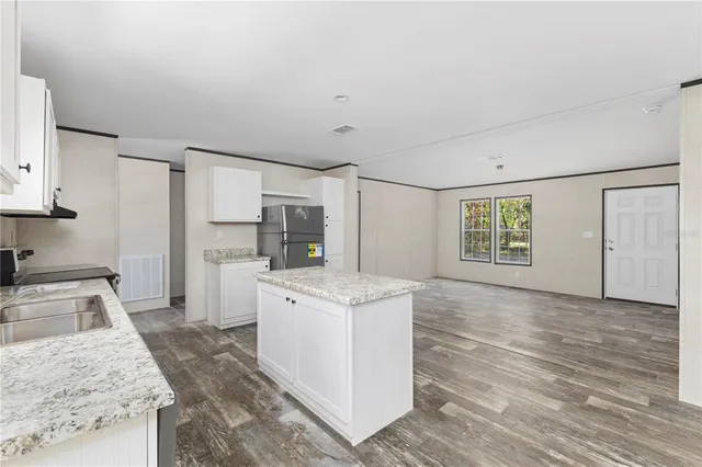 a kitchen with a stove and a white cabinets