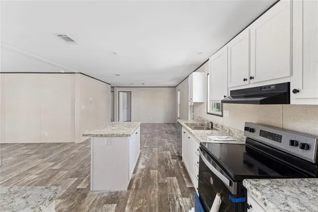 a kitchen with a stove and a refrigerator