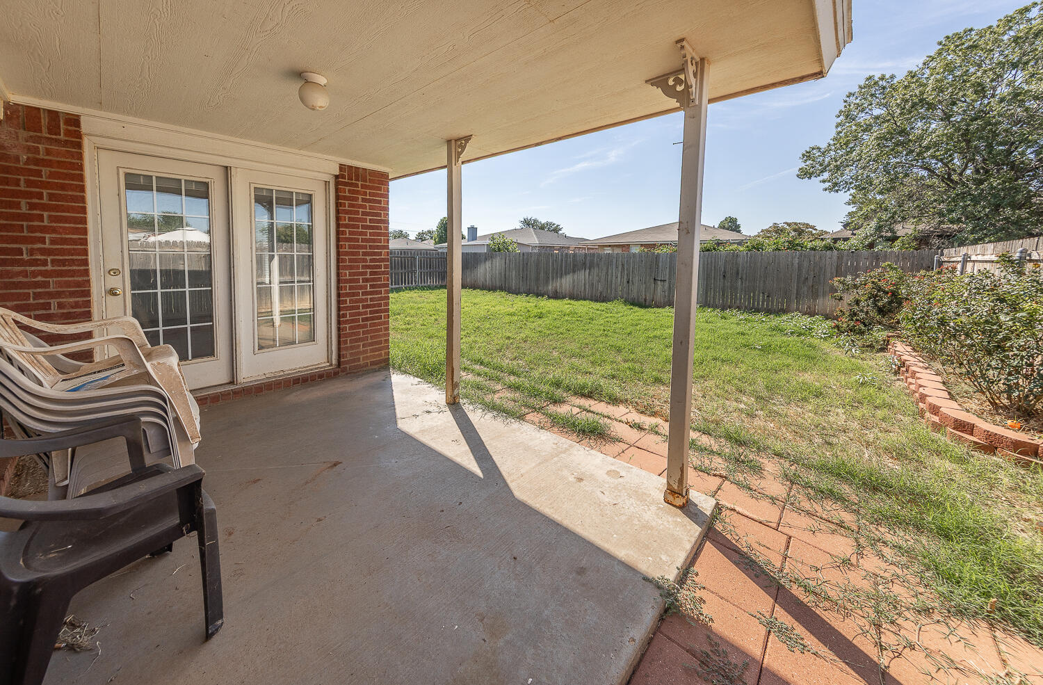 6109 13th Street Lubbock, TX 79416 - Photo 19 of 24 a view of a balcony with chair and floor to ceiling window