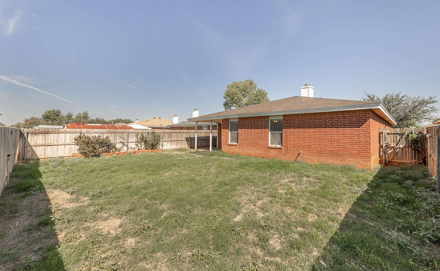 6109 13th Street Lubbock, TX 79416 - Photo 23 of 24 a front view of a house with a yard