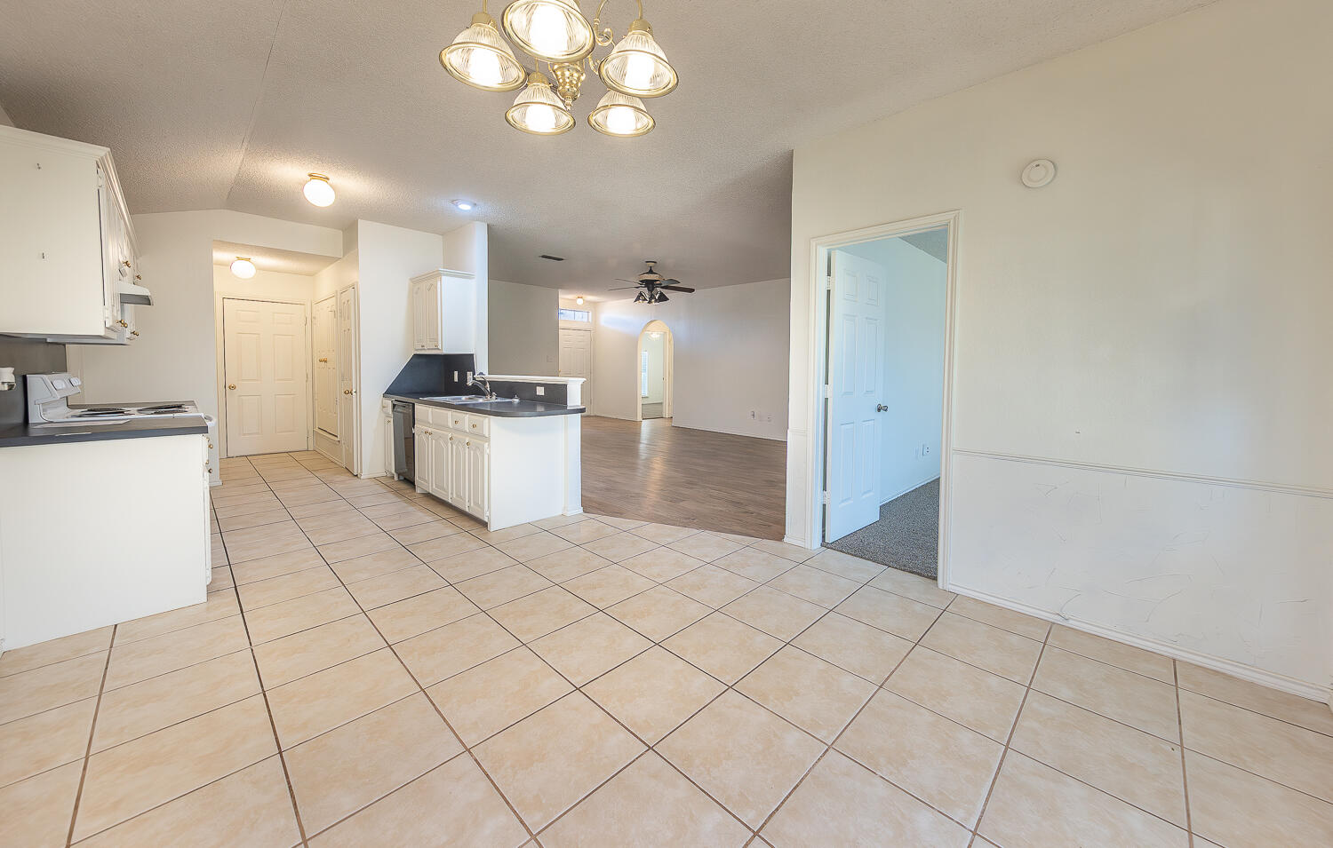 6109 13th Street Lubbock, TX 79416 - Photo 7 of 24 a open kitchen with a sink and cabinets