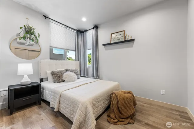 a bedroom with a bed and a mirror