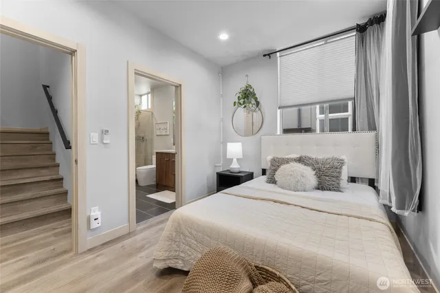 a bedroom with a large bed and a large mirror