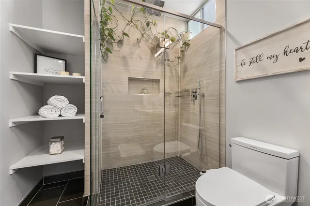 a bathroom with a toilet and a shower