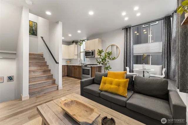 a living room with furniture and wooden floor