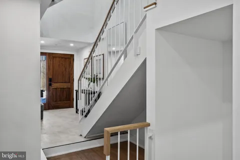 a view of entryway with wooden floor and stairs