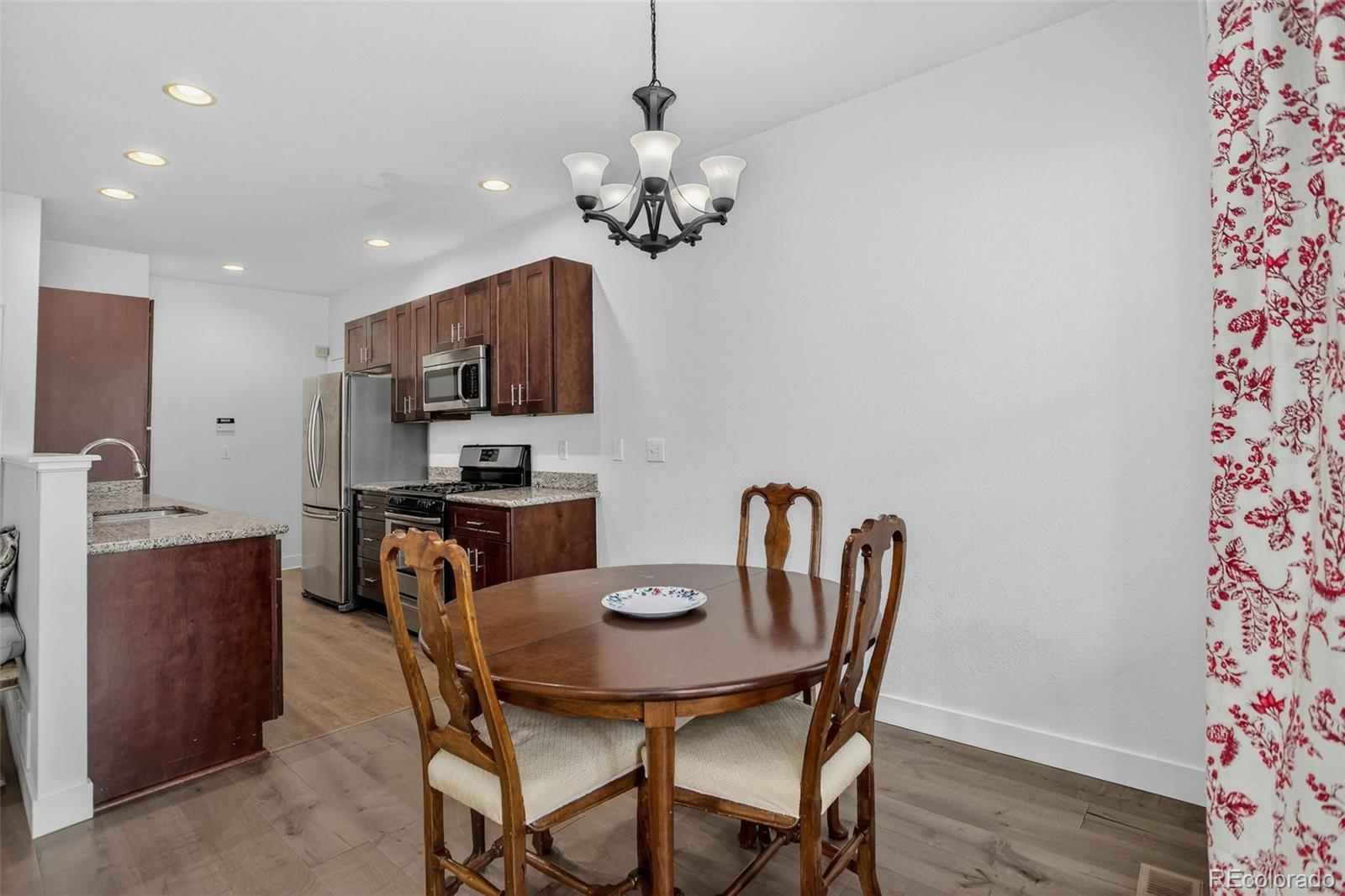 203 Remuda Lane, Unit 203 Lafayette, CO 80026 - Photo 12 of 35 a dining room with furniture and chandelier