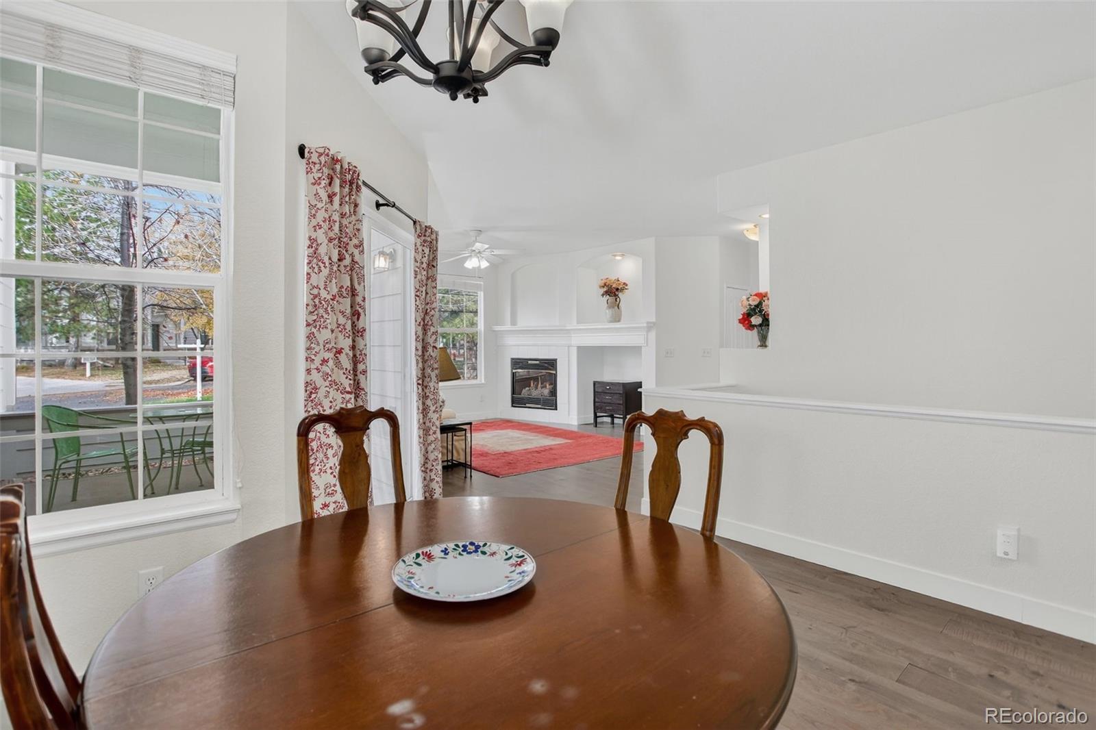 203 Remuda Lane, Unit 203 Lafayette, CO 80026 - Photo 14 of 35 a dining room with furniture a fireplace and wooden floor