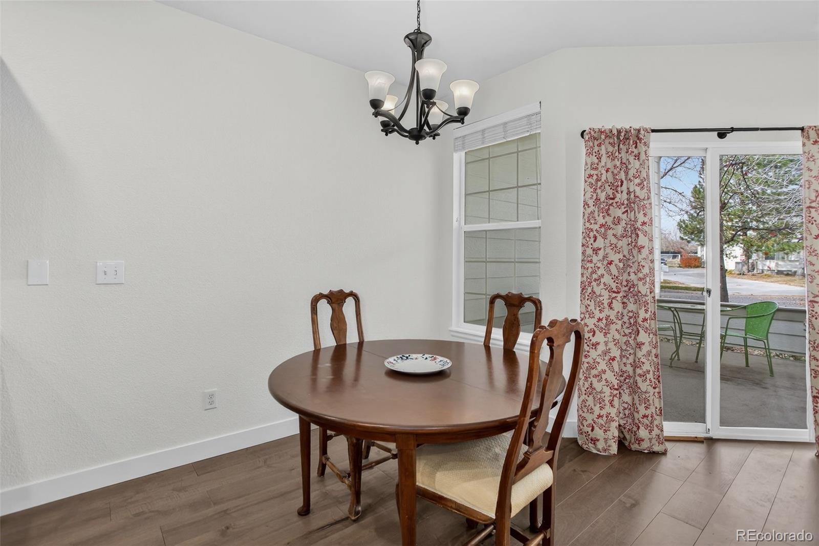 203 Remuda Lane, Unit 203 Lafayette, CO 80026 - Photo 15 of 35 a view of a dining room with furniture window and wooden floor
