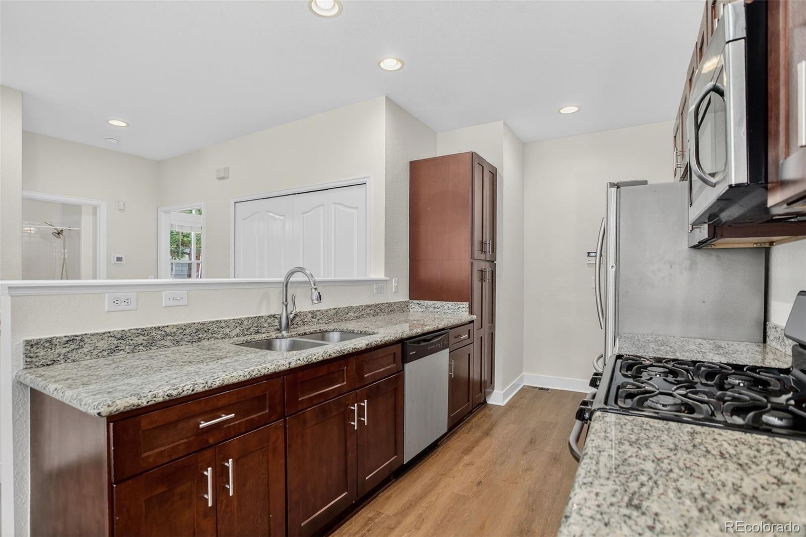 203 Remuda Lane, Unit 203 Lafayette, CO 80026 - Photo 8 of 35 a kitchen with stainless steel appliances granite countertop a sink stove and refrigerator