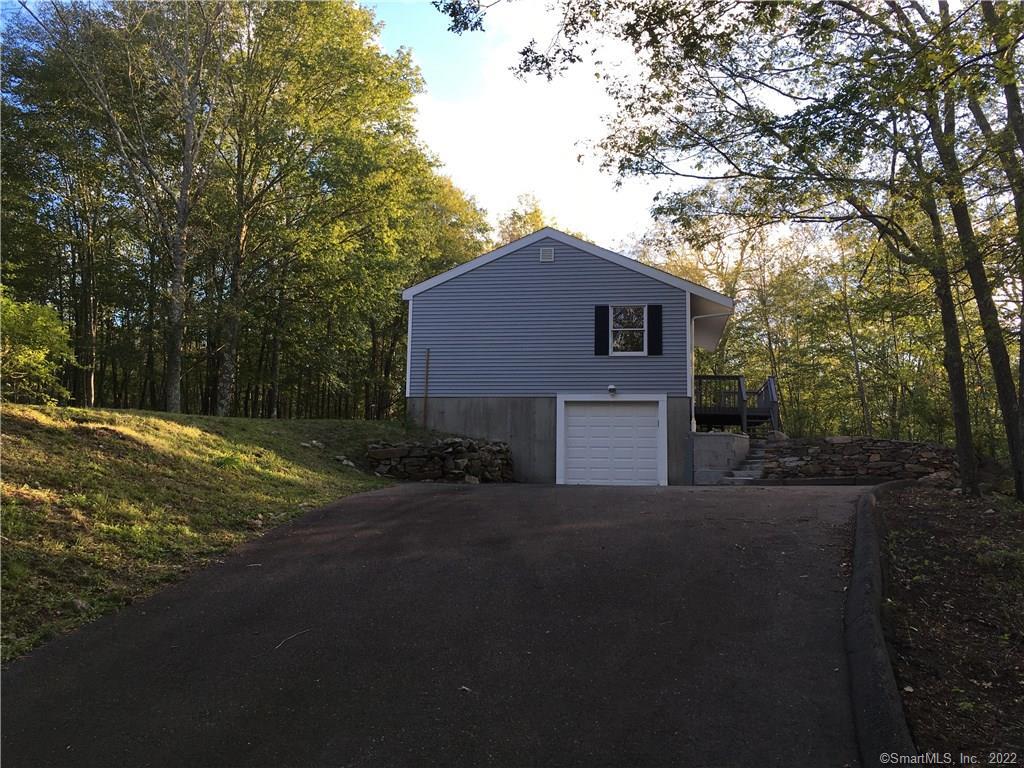 a house that has a tree in front of it