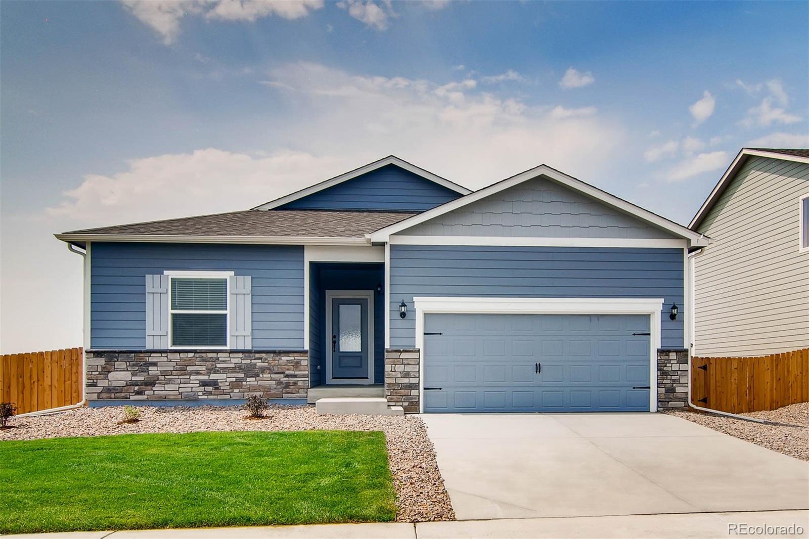 2299 Murray Street Mead, CO 80504 - Photo 1 of 17 a front view of a house with a yard and garage