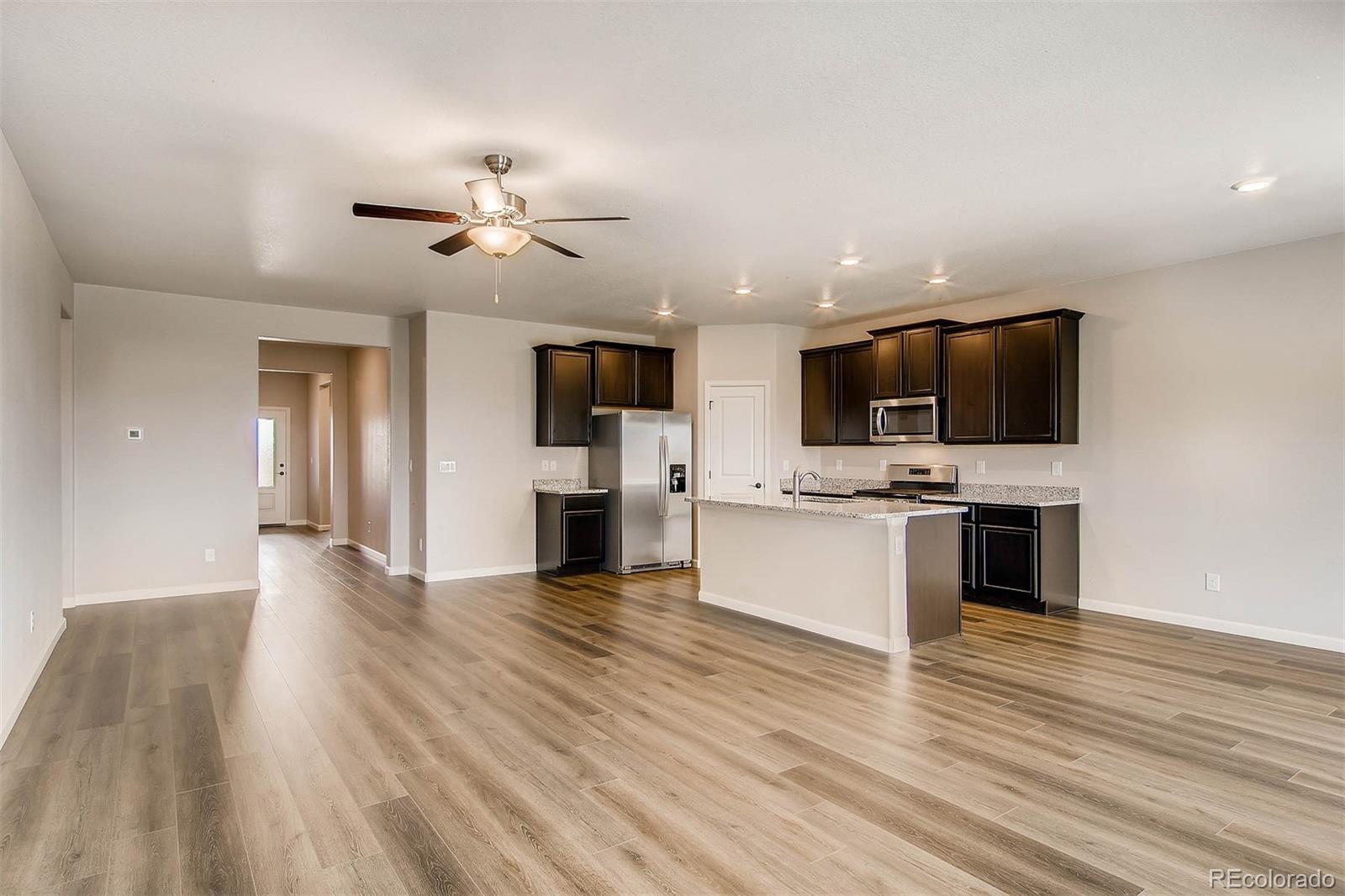 2299 Murray Street Mead, CO 80504 - Photo 13 of 17 a view of an empty room with kitchen and fireplace