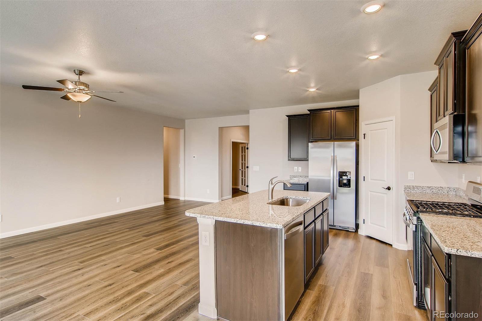 2299 Murray Street Mead, CO 80504 - Photo 16 of 17 a kitchen with a sink appliances and cabinets