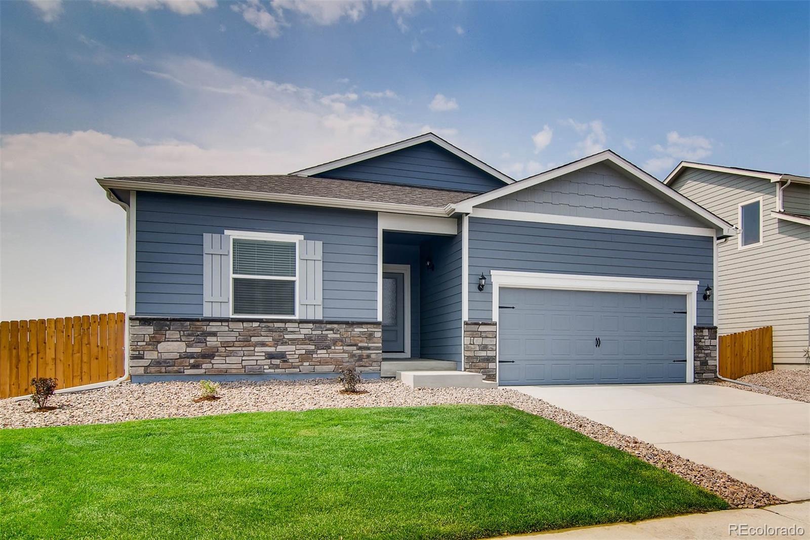 2299 Murray Street Mead, CO 80504 - Photo 2 of 17 a front view of a house with a yard and garage